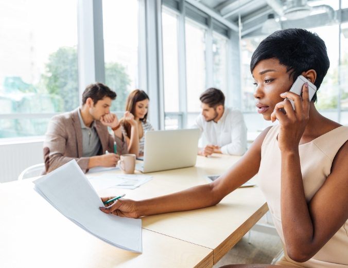 serious-businesswoman-with-documents-talking-on-P9Q6LX6@2x.jpg